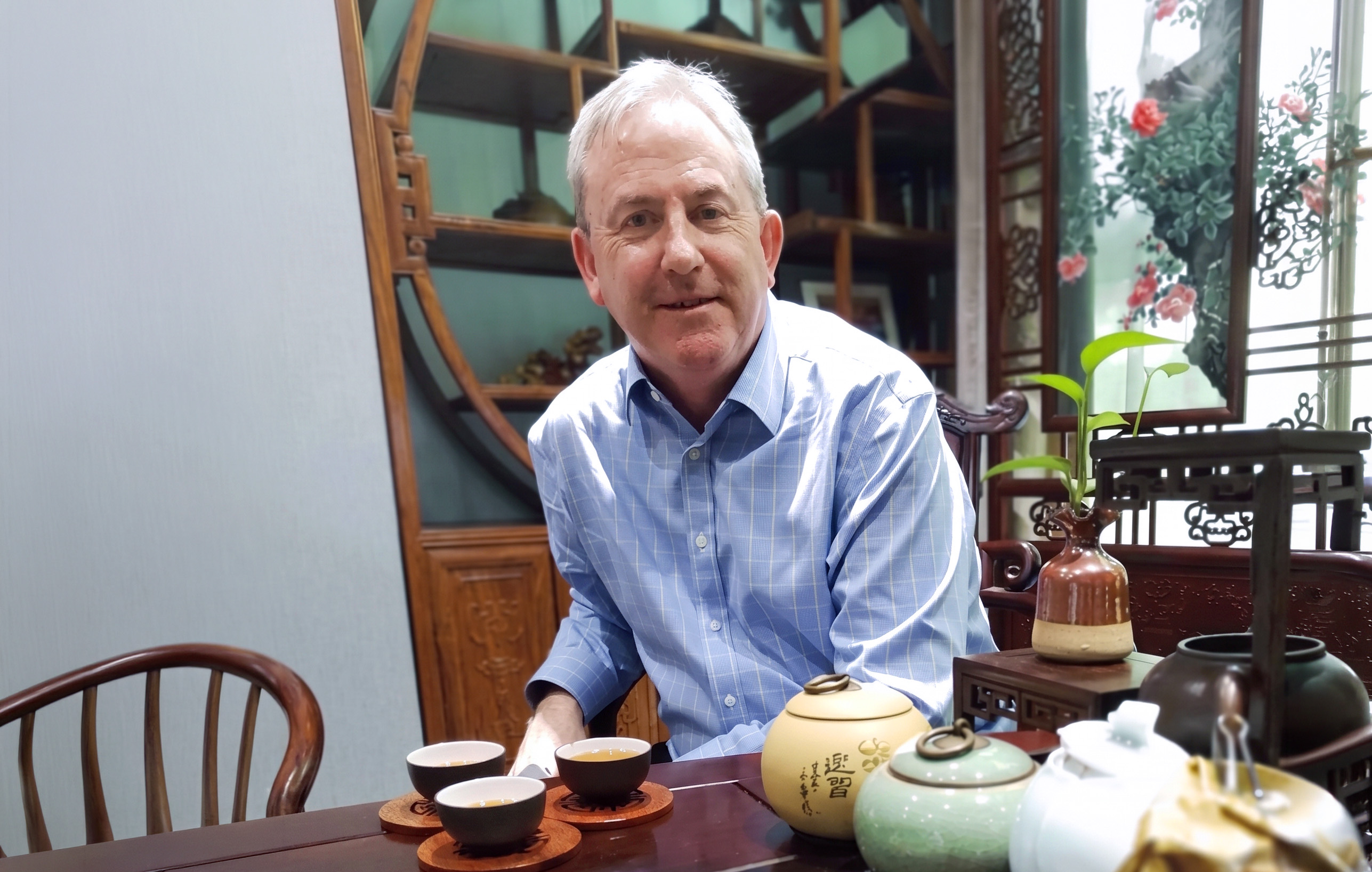 David Thomas at a Chinese tea table, three cups of tea poured in front of him