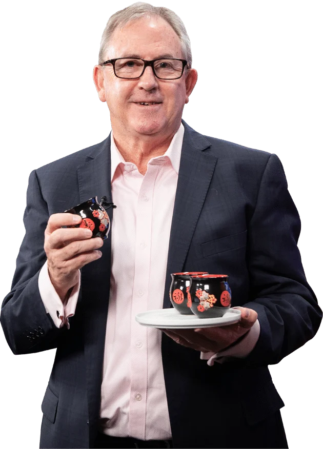 David Thomas holding a pair of Chinese tea cups