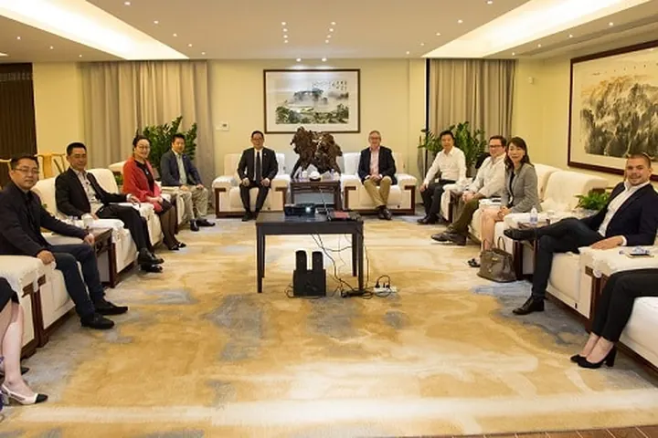 Delegates seated around the edge of a formal meeting room