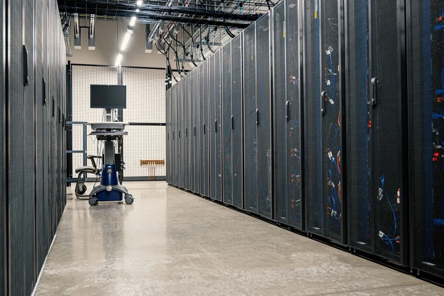 A data centre corridor lined on both sides with server racks