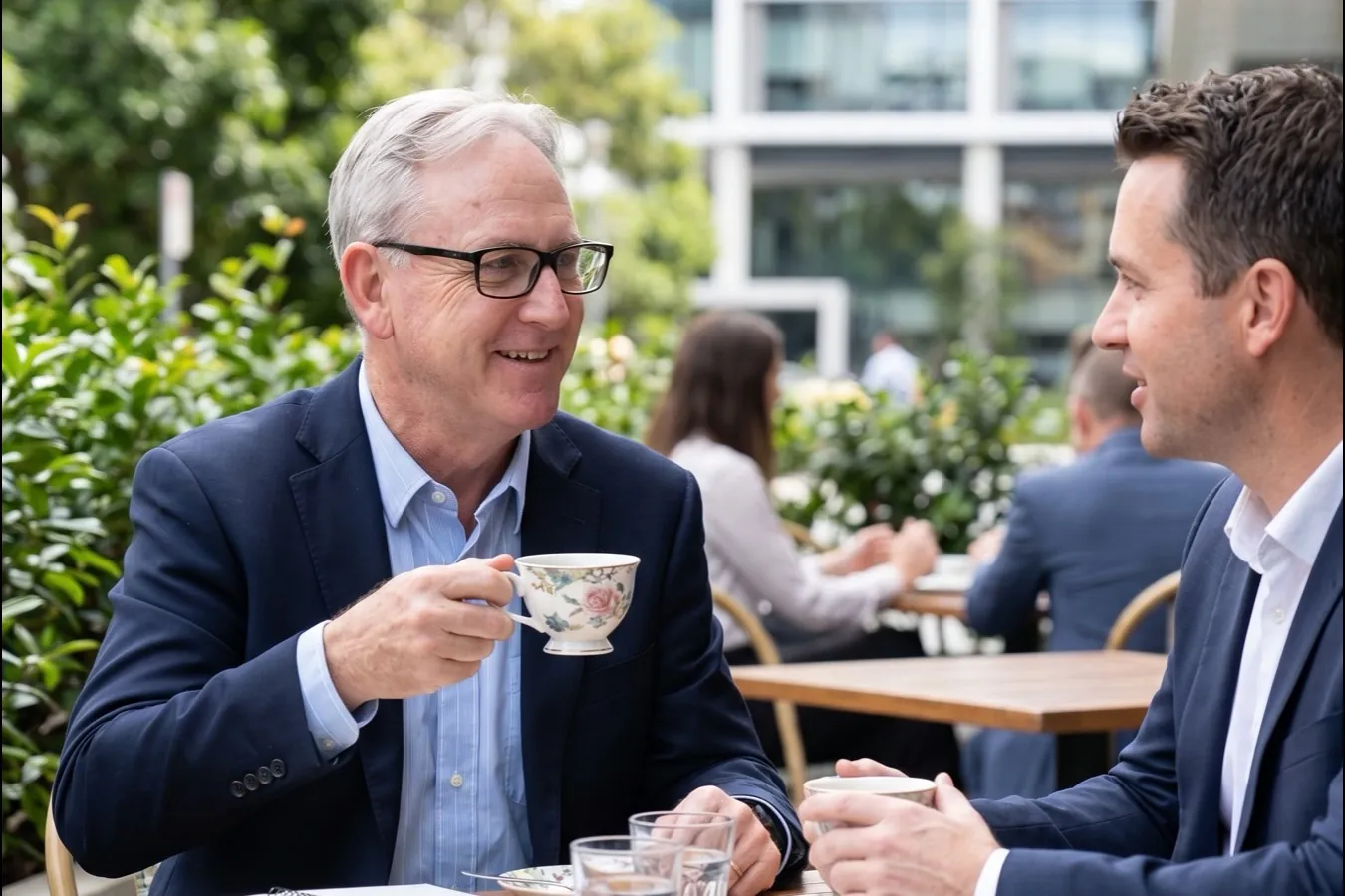 David Thomas over tea with a business contact, mid-conversation